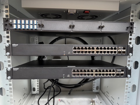 Network switches and fiber termination hardware installed in an outdoor equipment enclosure