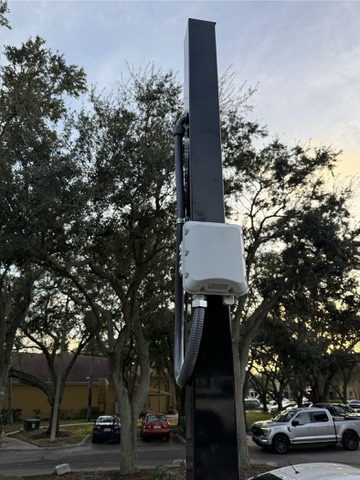 Pole-mounted field equipment with protected pathway routing