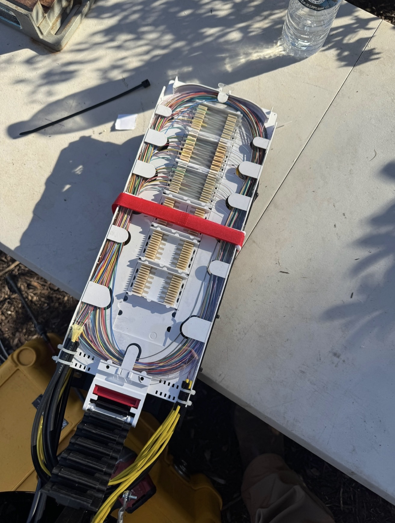 Organized fiber strands routed through a splice tray